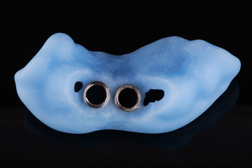 not a large surgical pattern for implantation of the front tooth; top view on a black background