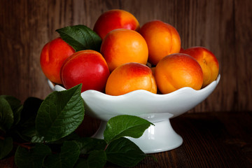 Apricots in a white porcelain vase
