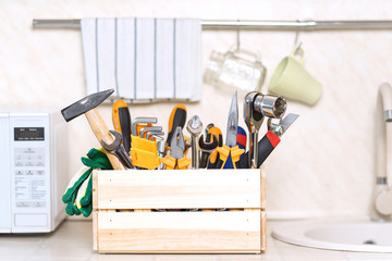 construction tools in wooden box in kitchen