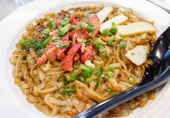 Noodle Fried soy sauce with roasted red pork on plate / Malaysian food