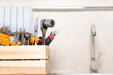 construction tools in wooden box in kitchen