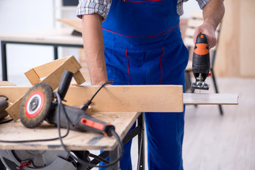 Young male carpenter working indoors 