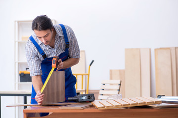 Young male carpenter working indoors 