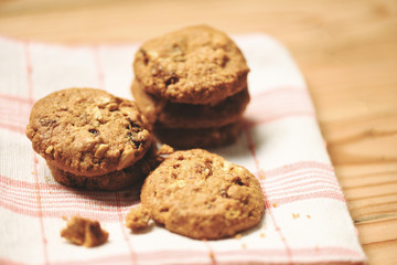 cookies dried currants and nut on tablecloth on wooden table