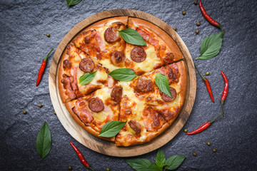 Pizza on wooden tray and chilli basil leaf top view / delicious tasty fast food italian traditional pizza cheese