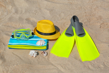 Set of different stylish beach accessories on sand