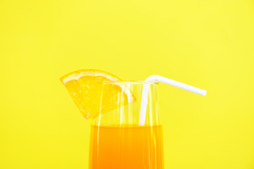 Orange juice summer glass with piece orange fruit with yellow