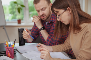 Cropped shot of a teenage girl working on a project with her tutor after the lessons, copy space. Female teen student and her teacher brainstorming together