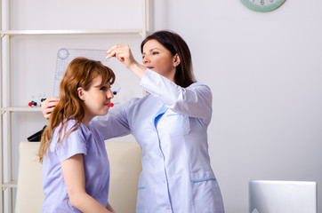 Female doctor checking patient's joint flexibility with goniomet