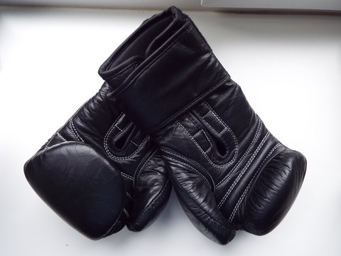 black Boxing gloves on a white windowsill