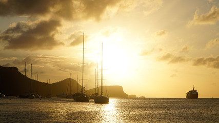 Sunset over Union Island with Sail boat yachts in the Tobago Cays near Saint Vincent and the...