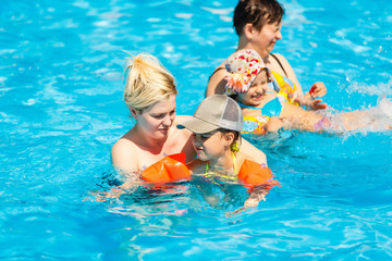 happy little girl and mother in pool