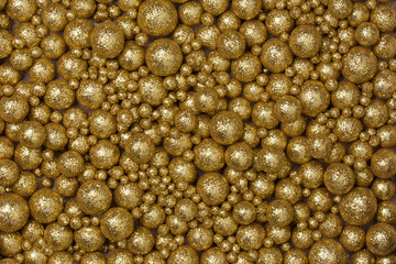 Christmas background with big and small golden glitter pellets