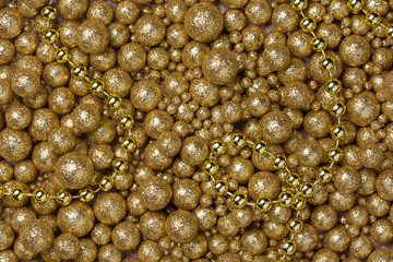 Christmas background with big and small golden glitter balls and golden bead chain