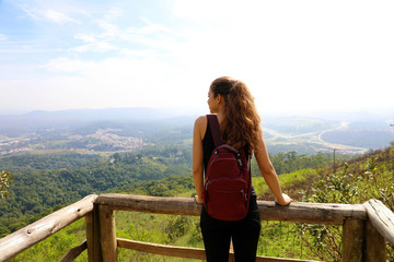 Fototapeta na wymiar Hiker with backpack enjoying view from Jaragua Peak, Sao Paulo, Brazil