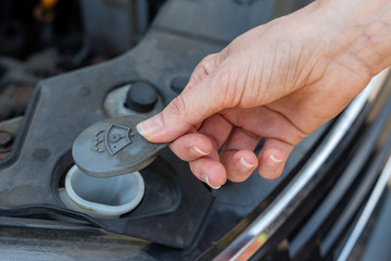Daily diagnostics of the car by the driver. Refilling car washer fluid.