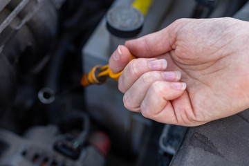 Car dipstick for oil level measurements. Checking the parameters of the car engine.