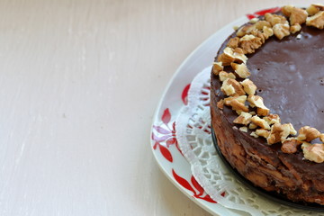 Cake without baking cookies and chocolate. Decorated with walnut crumbs. On a shabby aged background.