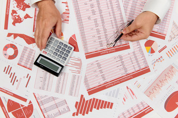 Flat top view of businessman working and calculating finance, reads and writes reports. Business...
