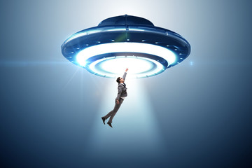 Flying saucer abducting young businessman 