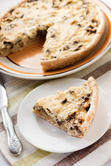 Slice of chicken tart with mushrooms and cheese on a plate