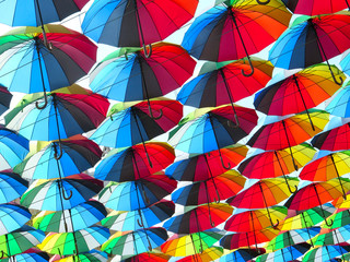 Fototapeta na wymiar many colored umbrellas in the sky. Multicolored background. Umbrella. Weather 