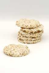 Grain crispbreads on white background. Puffed whole grain crispbread. Dieting Eating Concept. Copy space