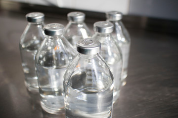 bottles with solutions on the medical table