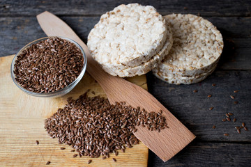 flax seeds and loaves on a wooden table