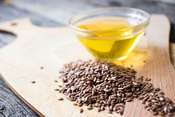 flax seeds and oil on wooden table