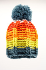 Colorful winter knitted hat on a white background.