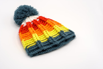 Colorful winter knitted hat on a white background.