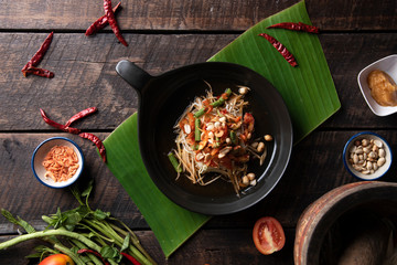 Som Tam Thai - Papaya Salad Thai Food Style on wooden table background. Thai Food Concept. Top View