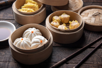 Dim sum on wooden table. Chinese food concept.
