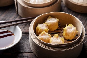Dim sum on wooden table. Chinese food concept.