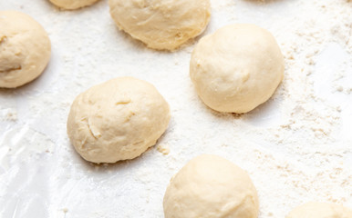 Fototapeta na wymiar Dough pieces on the table in the kitchen