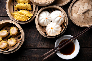 Dim sum on wooden table. Chinese food concept.