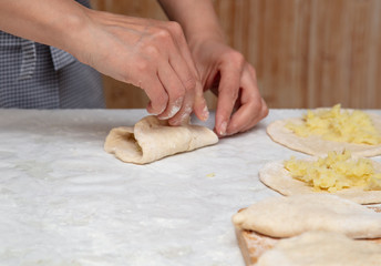 The hostess prepares the pies in the kitchen