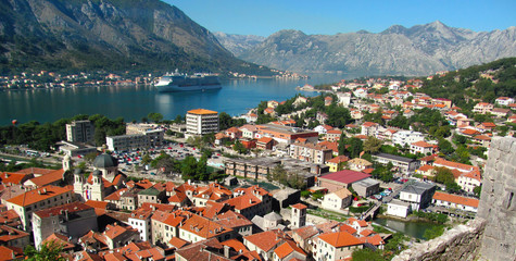 Naklejka na ściany i meble Landscape of Kotor bay, Montenegro, Europe. Beautiful view with the sea, mountains, old city, cruise ship, harbor, green trees and blue sky in a sunny summer day. 