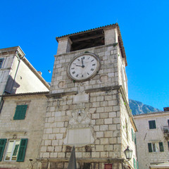 Fototapeta na wymiar Old architecture of Kotor, Montenegro, Europe. Beautiful view of ancient city with blue sky and green trees on a summer sunny day.