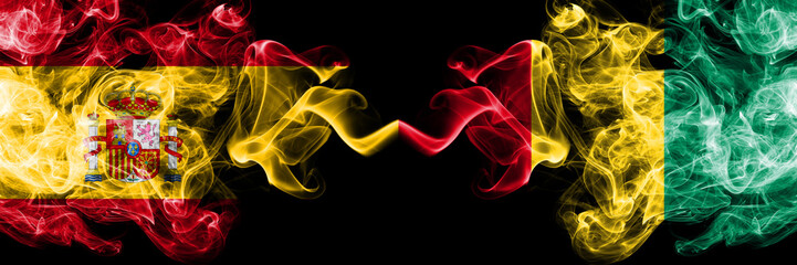 Spain vs Guinea, Guinean smoky mystic flags placed side by side. Thick colored silky smokes flag of Spanish and Guinea, Guinean