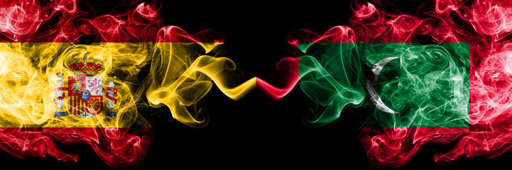 Spain vs Maldives, Maldivian smoky mystic flags placed side by side. Thick colored silky smokes...