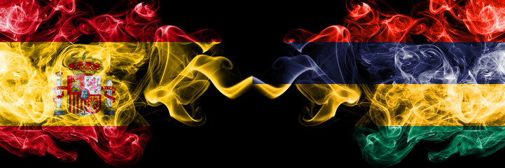 Spain vs Mauritius, Mauritian smoky mystic flags placed side by side. Thick colored silky smokes flag of Spanish and Mauritius, Mauritian