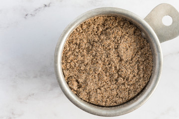 Ground Cardamon in a Measuring Cup