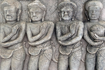 Fototapeta na wymiar Detail of carvings stone Bas-Relief depicting Apsara of Khmer Culture in Thailand