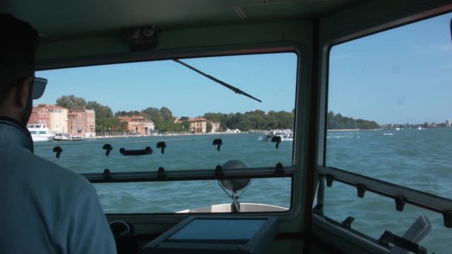 On a ferry from venice to the island lido. Lots of those small ferry boats cross the channel to lido to transport tourists and commuters. the boats are like a subway for many people.