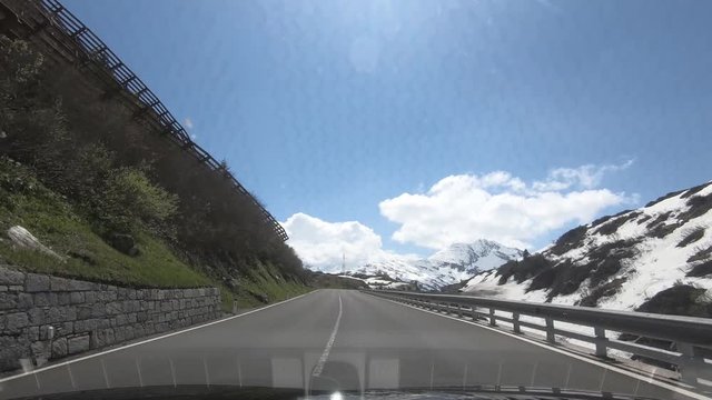 Driving a Car on winding rouads on the Arlberg in Austria, Tirol,