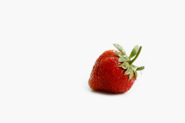whole red strawberry on isolated white background close up