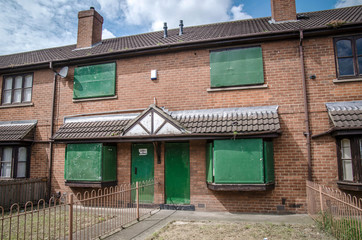Boarded-up terrace houses on housing estate, UK