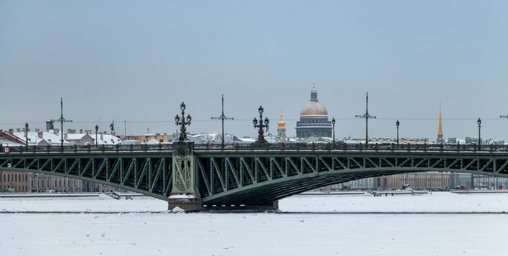 Winter panorama of Saint-Petersburg with Neva river, Isaac cathedral dome and Trinity bridge. Famous landmarks in Russia